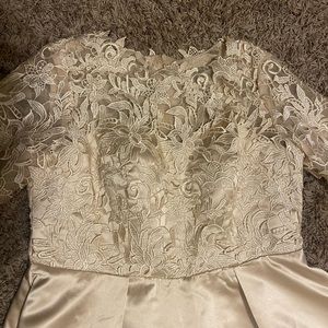 Women’s tea length formal dress. Sleeves are have length.